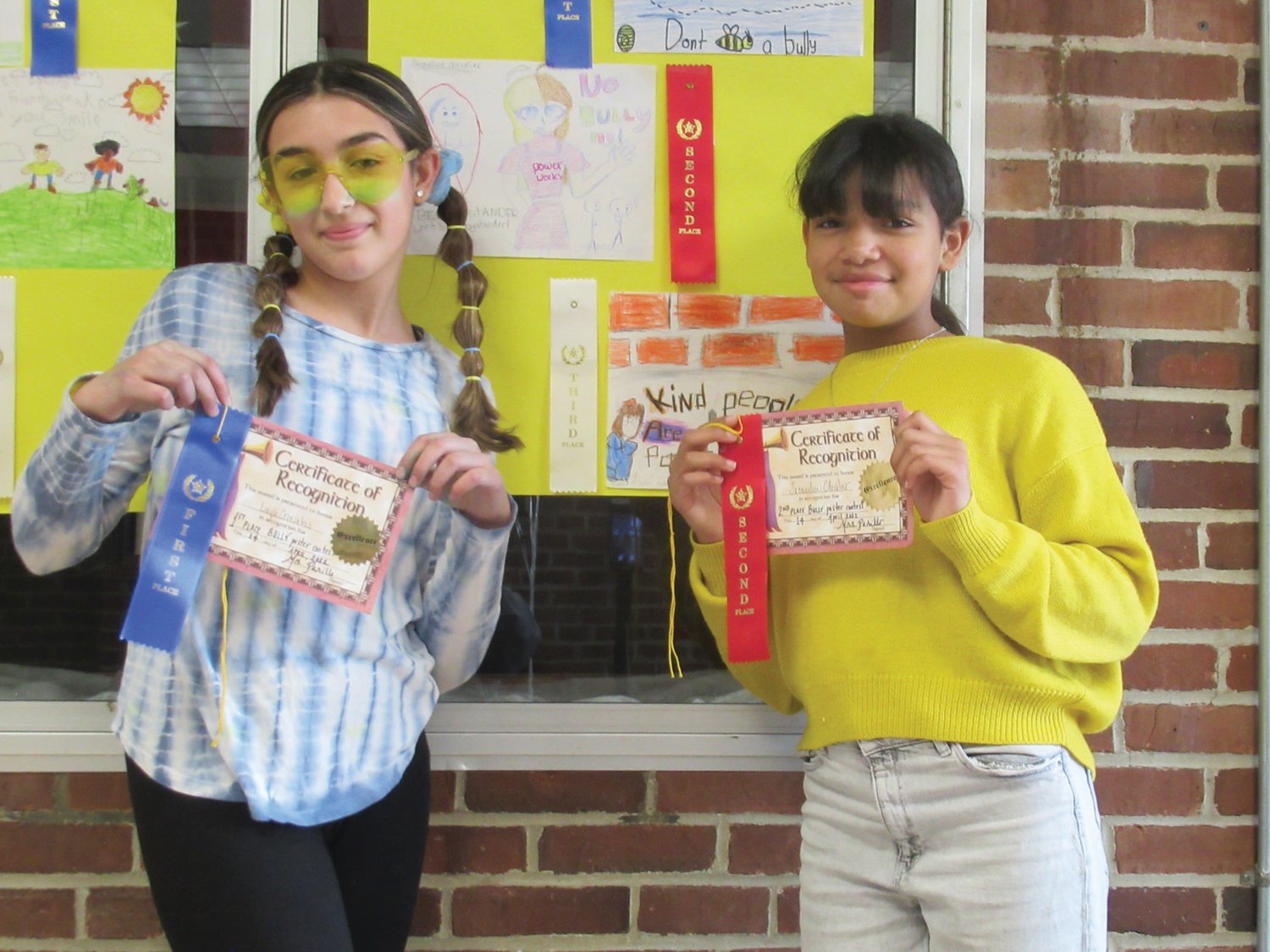 AWESOME ARTISTS: Layla Gonsalves (left) took first in Winsor Hill’s Bully Poster contest while Jacqueline Chevalier was second and Victoria Salois was third.